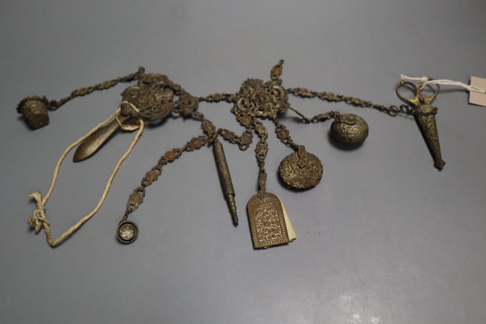 A Victorian embossed metal chatelaine, with seven attached domestic accessories, height 36cm